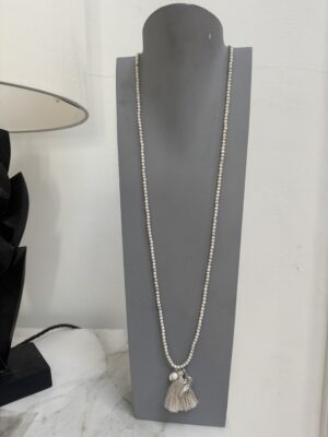 Sample Sale-26. Long beaded cream necklace with fabric tassel and charms.